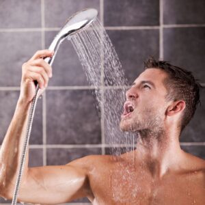 Handsome man taking a shower and enjoying it